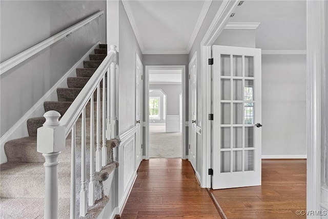 interior space with stairs, ornamental molding, and wood finished floors