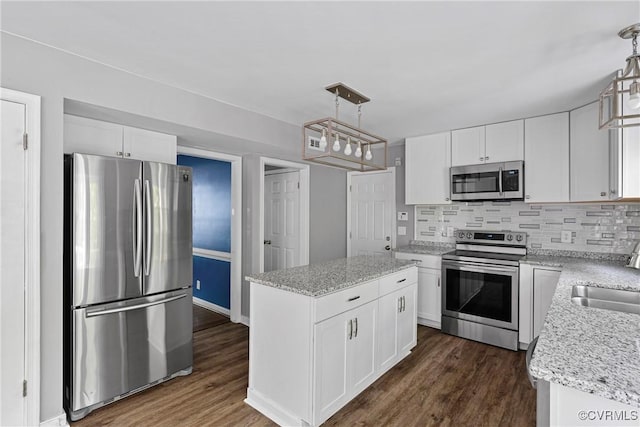 kitchen featuring a sink, backsplash, stainless steel appliances, and dark wood-style floors