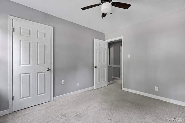 unfurnished bedroom with baseboards, a ceiling fan, and carpet