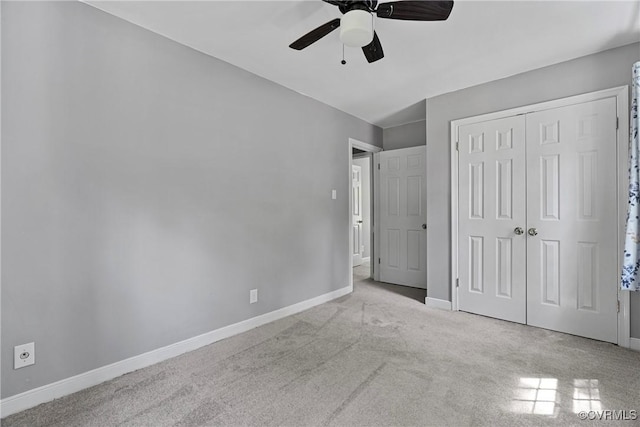 unfurnished bedroom featuring baseboards, carpet, ceiling fan, and a closet