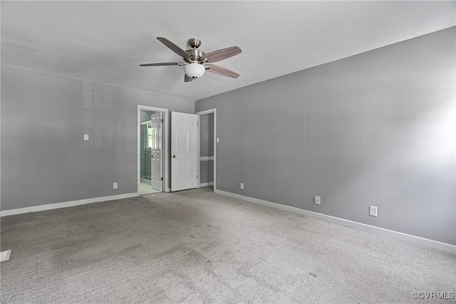 carpeted empty room with baseboards and ceiling fan