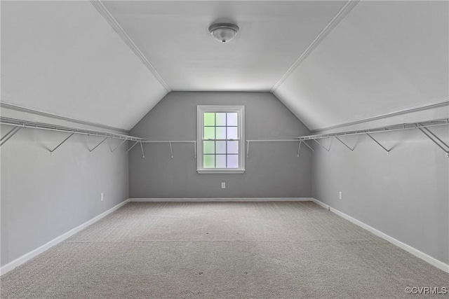 walk in closet with carpet flooring and lofted ceiling