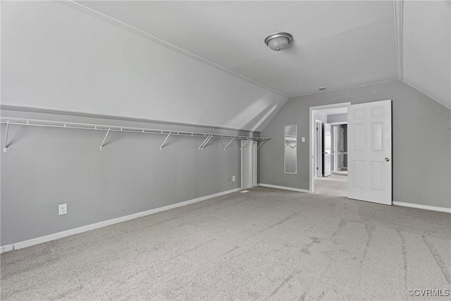 additional living space with carpet flooring, baseboards, and lofted ceiling