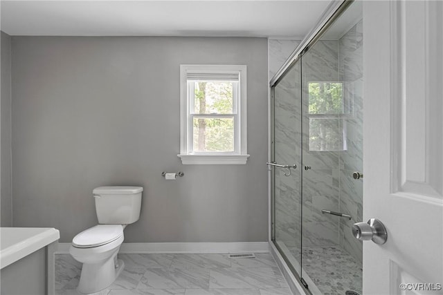 full bath featuring baseboards, a stall shower, toilet, and marble finish floor