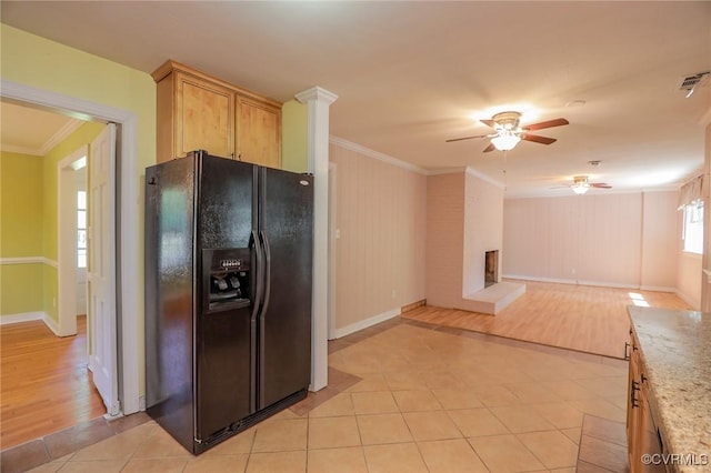kitchen featuring crown molding, a ceiling fan, light tile patterned floors, and black fridge with ice dispenser