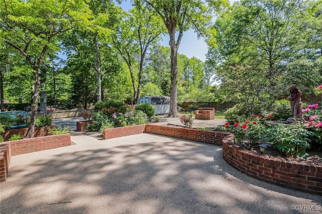 view of patio / terrace featuring fence, an outdoor structure, and a shed