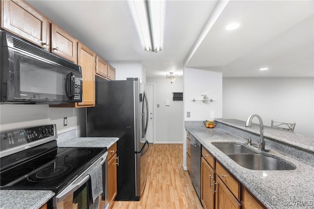 3218 Matilda Cv Unit 104, Henrico, VA 23294 - kitchen featuring stainless steel appliances, a sink, light wood-style flooring, light stone counters, and brown cabinets