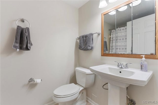 3218 Matilda Cv Unit 104, Henrico, VA 23294 - bathroom featuring toilet, baseboards, curtained shower, and a sink