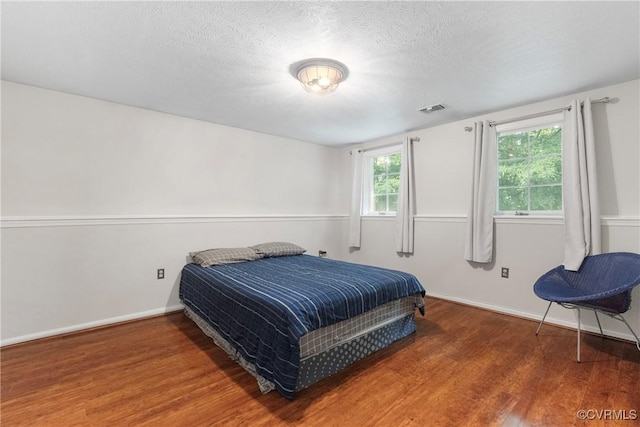 3218 Matilda Cv Unit 104, Henrico, VA 23294 - bedroom featuring wood finished floors, a textured ceiling, and baseboards