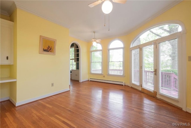 7704 Quail Hollow Rd, Mc Kenney, VA 23872 - unfurnished dining area featuring a baseboard heating unit, ceiling fan, ornamental molding, and plenty of natural light