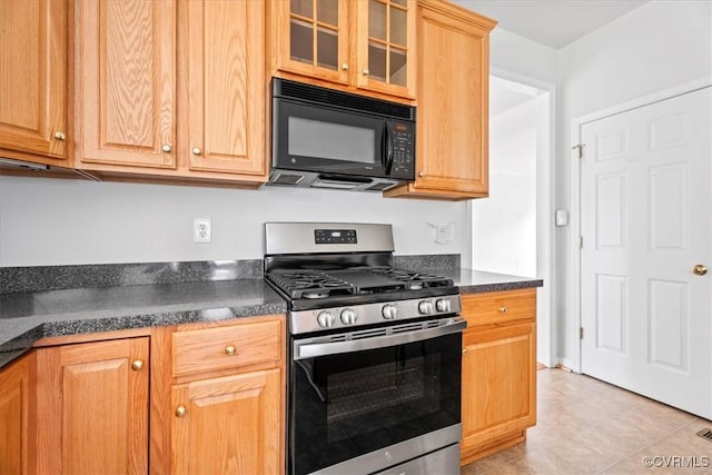 156 Hawk Nest Ct, Richmond, VA 23227 - kitchen with black microwave, gas stove, dark countertops, glass insert cabinets, and light tile patterned floors