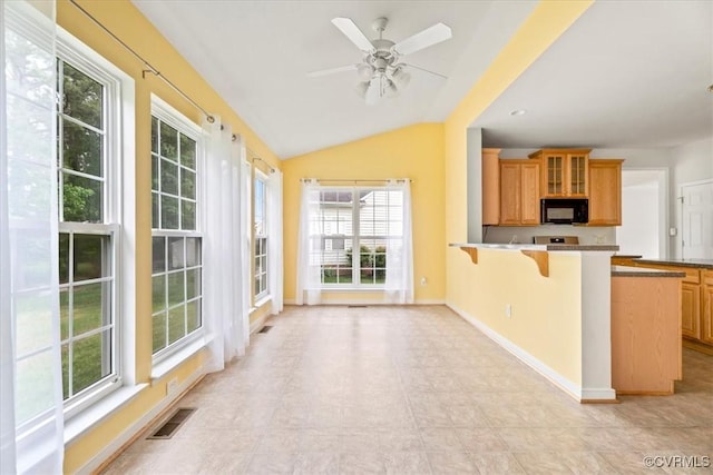 156 Hawk Nest Ct, Richmond, VA 23227 - kitchen with black microwave, healthy amount of natural light, a breakfast bar, a peninsula, and lofted ceiling