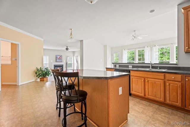 156 Hawk Nest Ct, Richmond, VA 23227 - kitchen featuring a ceiling fan, a kitchen island, dark countertops, a breakfast bar area, and open floor plan