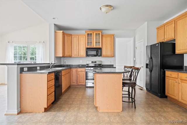 156 Hawk Nest Ct, Richmond, VA 23227 - kitchen with black appliances, a kitchen bar, dark countertops, and a kitchen island