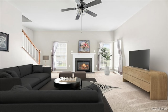 156 Hawk Nest Ct, Richmond, VA 23227 - living room featuring light colored carpet, stairs, a fireplace with flush hearth, and a ceiling fan