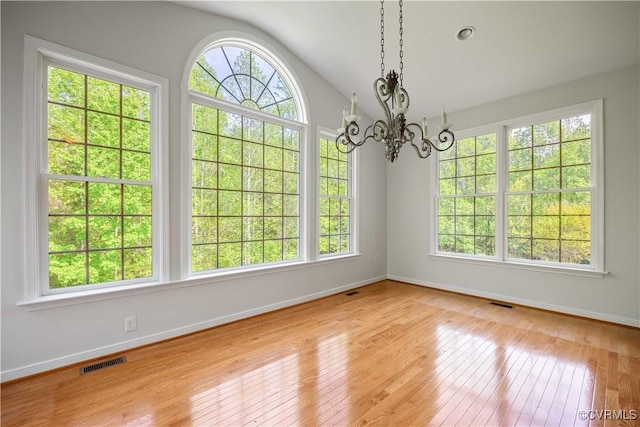 interior space featuring hardwood / wood-style floors, visible vents, and a wealth of natural light