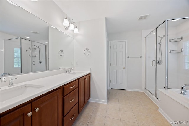 bathroom featuring visible vents, a stall shower, tile patterned flooring, and a sink