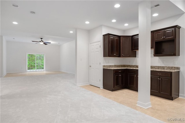 kitchen featuring recessed lighting, a ceiling fan, baseboards, dark brown cabinets, and light colored carpet
