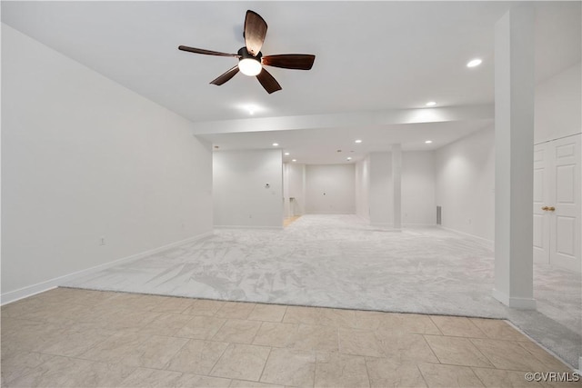 spare room featuring recessed lighting, a ceiling fan, light carpet, and baseboards