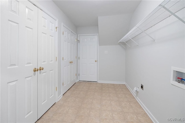 clothes washing area with hookup for a washing machine, laundry area, and baseboards