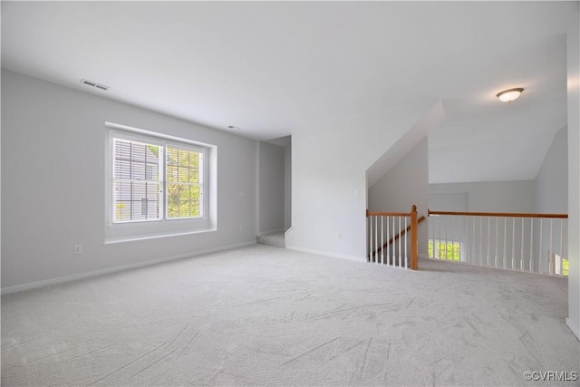 additional living space featuring visible vents, carpet flooring, and baseboards