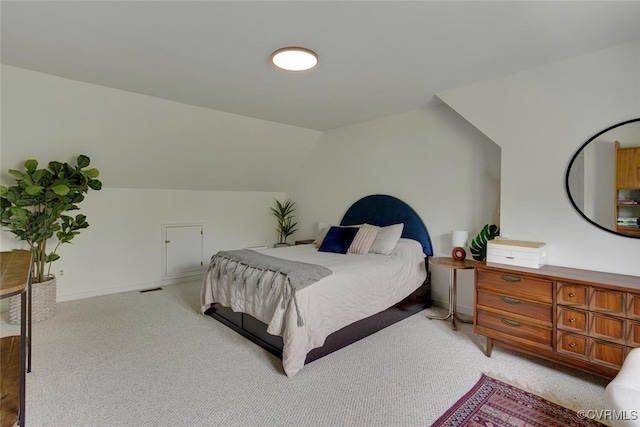 bedroom featuring lofted ceiling and light colored carpet