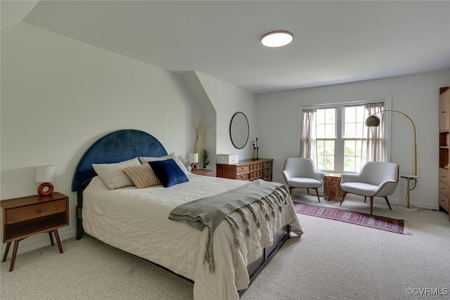 bedroom featuring baseboards and light colored carpet