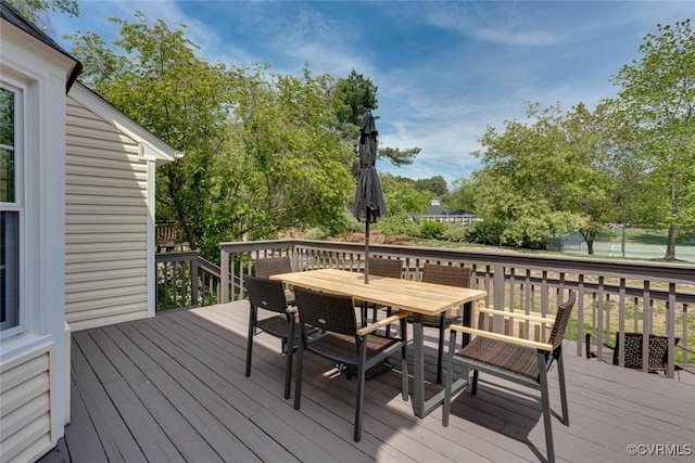 wooden terrace with outdoor dining space