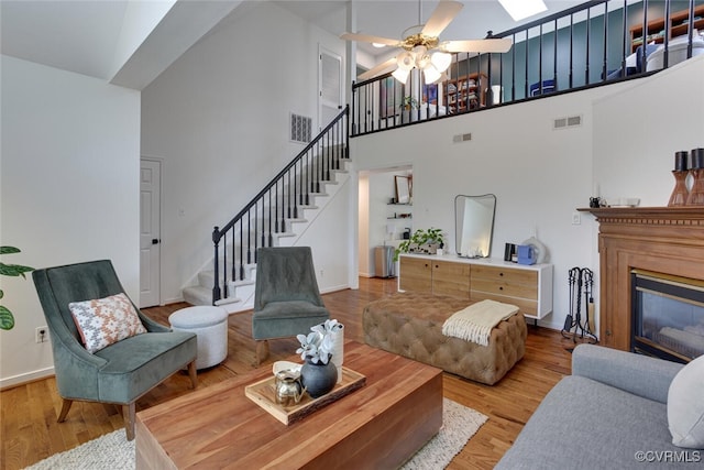 living room featuring visible vents, wood finished floors, and stairway