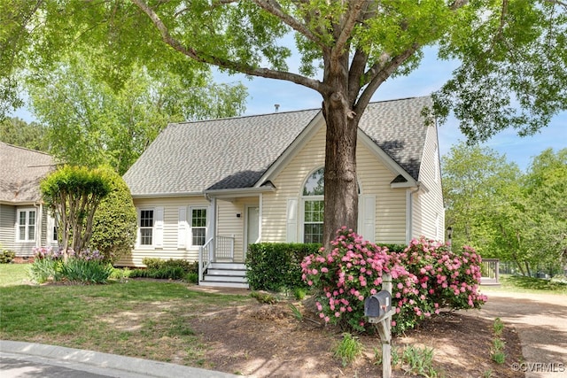view of front facade featuring roof with shingles