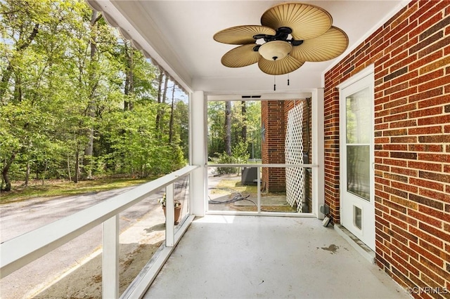 unfurnished sunroom with ceiling fan