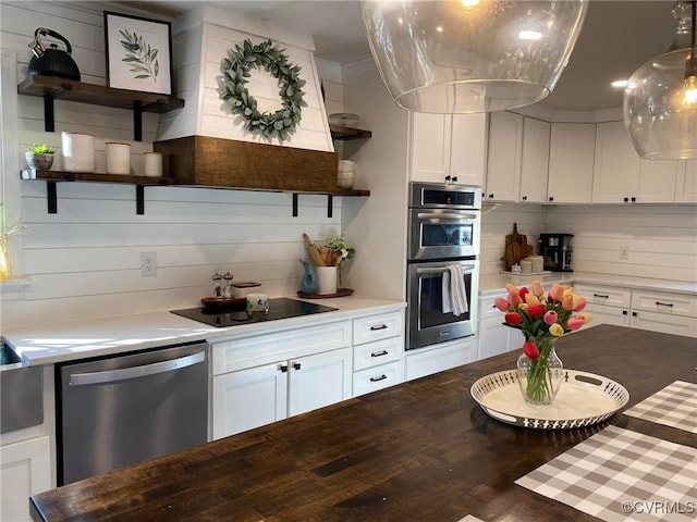 kitchen with hanging light fixtures, white cabinets, open shelves, and stainless steel appliances