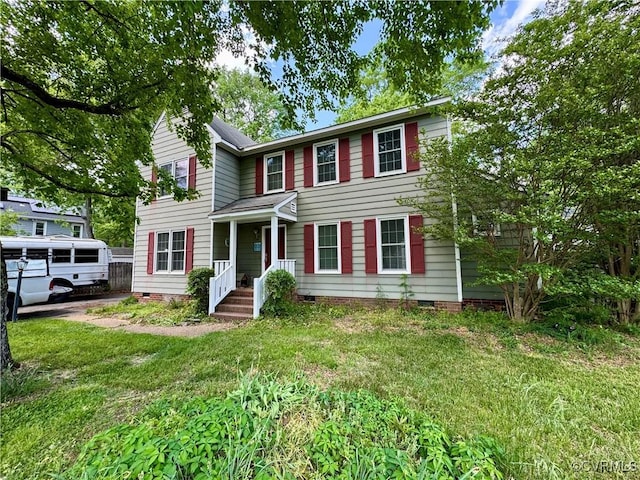 colonial inspired home with a front yard and crawl space