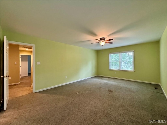 carpeted spare room featuring a ceiling fan, baseboards, and visible vents