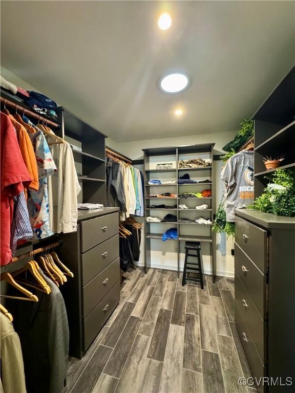 spacious closet with dark wood-type flooring