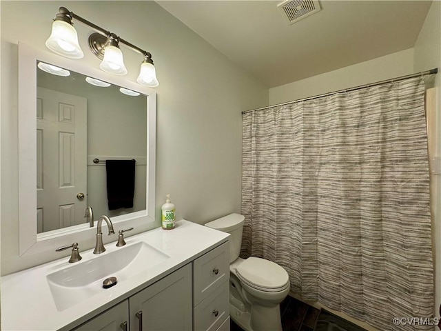 full bathroom with visible vents, wood finished floors, vanity, toilet, and lofted ceiling
