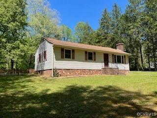 view of front of property with a front yard and a chimney