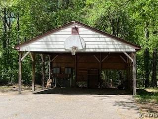 view of parking / parking lot featuring a detached carport and aphalt driveway