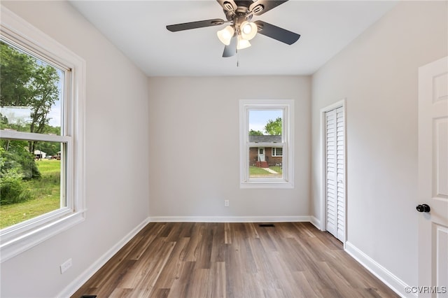 21300 W St, South Chesterfield, VA 23803 - empty room featuring dark wood-style floors, baseboards, and a healthy amount of sunlight