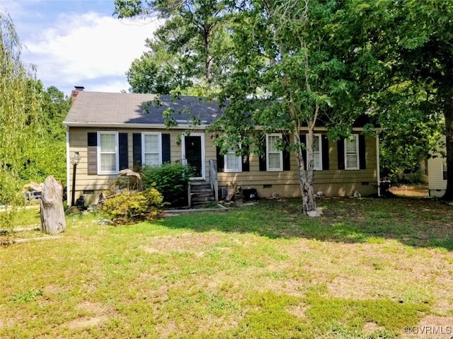 view of front of house featuring a chimney, a front lawn, and crawl space