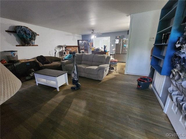 living room featuring a ceiling fan and wood finished floors