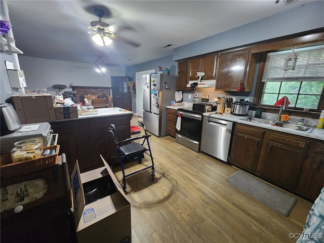kitchen featuring a ceiling fan, appliances with stainless steel finishes, dark brown cabinets, and light countertops
