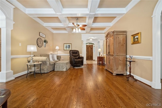 living room with beamed ceiling, arched walkways, ceiling fan, and decorative columns