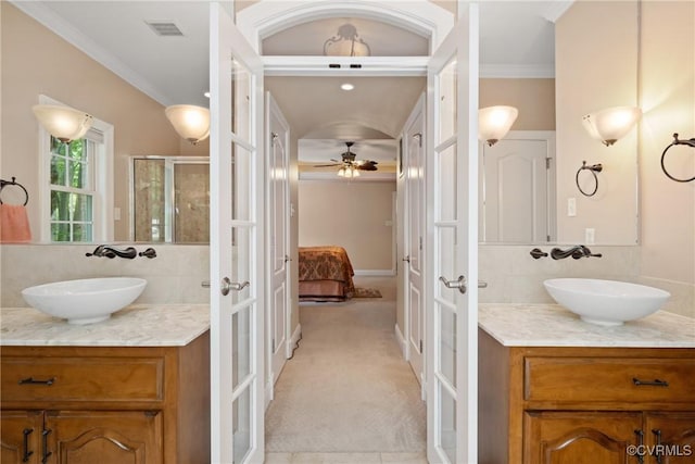 full bath with a sink, ensuite bathroom, and french doors