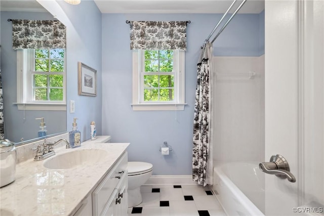 full bathroom with toilet, baseboards, plenty of natural light, and vanity