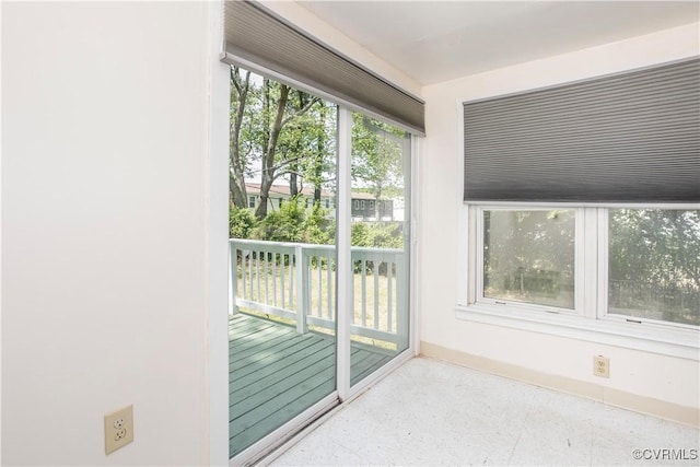 doorway with a healthy amount of sunlight and baseboards