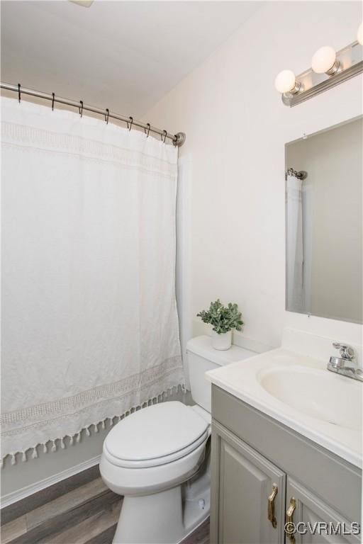 full bath with vanity, a shower with curtain, toilet, and wood finished floors