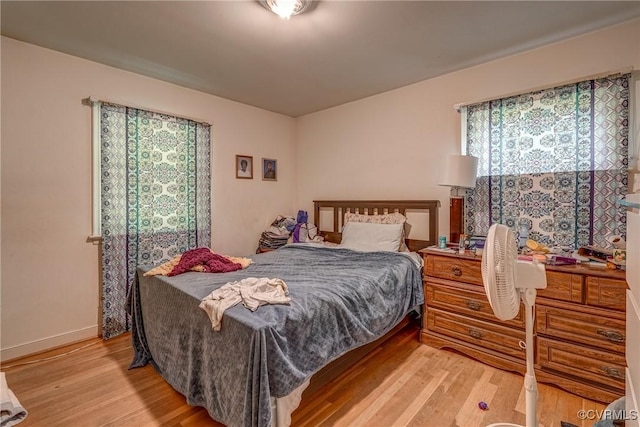 bedroom featuring light wood-type flooring and baseboards