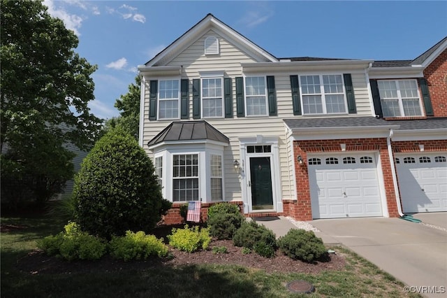 view of front of home with concrete driveway, brick siding, and an attached garage