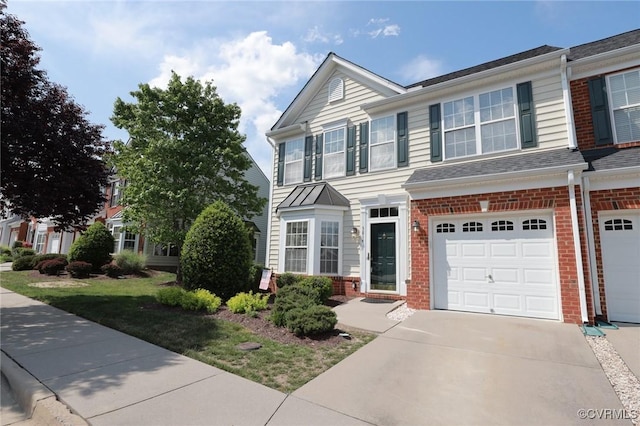 view of front facade with a garage, driveway, and brick siding